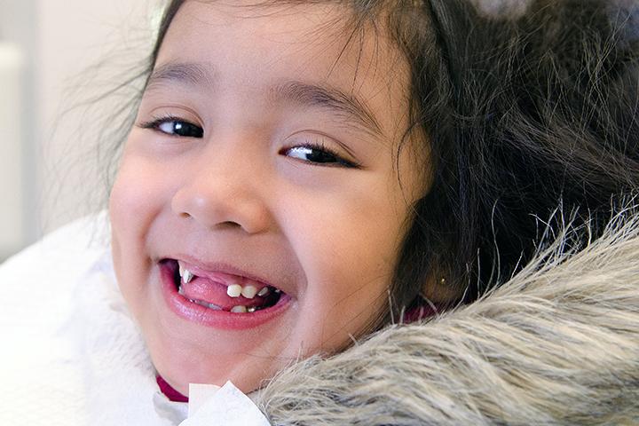 child in dental chair smiling